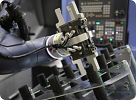 Doosan M-Series cobot tending a CNC machine